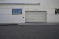 the front of a garage door with shutters on it sits in front of a building