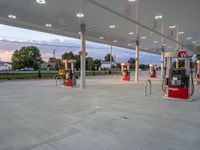 gas pumps sit on either side of each other at a gas station filled with service