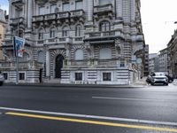 a picture of buildings and cars on a street in europe taken from the front seat seat