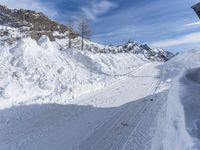 a person is skiing on a snowy hill side trail next to a lodge in winter