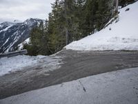 a motor bike stopped at a bend covered in snow by the side of the road