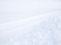 a young child is skiing on the snow covered slope and holding a sled in one hand