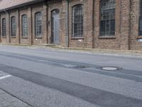 an empty street with windows on either side of it is littered from cars and signs