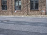 an empty street with windows on either side of it is littered from cars and signs