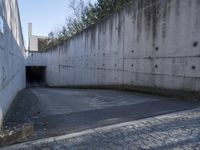 this is an image of a city tunnel at the end of the street and someone walking down to the exit