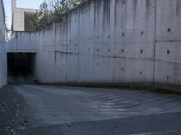 this is an image of a city tunnel at the end of the street and someone walking down to the exit
