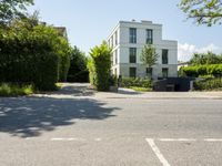 a residential house that is situated on the edge of a street with no cars parked in the driveway