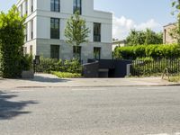 a residential house that is situated on the edge of a street with no cars parked in the driveway