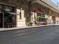 an old stone building next to a sidewalk with a traffic light in front of it