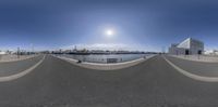 the fish eye view looking into the distance with the sky above it and the city skyline in the background