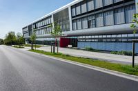 an empty street and an office building in the distance on a clear day in europe