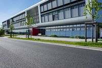 an empty street and an office building in the distance on a clear day in europe