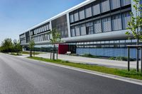 an empty street and an office building in the distance on a clear day in europe