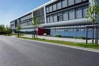 an empty street and an office building in the distance on a clear day in europe