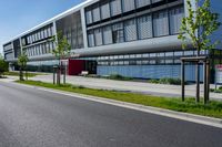 an empty street and an office building in the distance on a clear day in europe