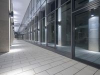 a room with some concrete and windows on the ground next to a building with a black sky