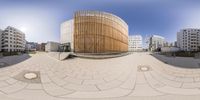 a 360 - view of a public building near the water features a wood slatt