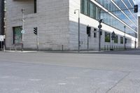 a red fire hydrant in front of an office building with glass windows and street lights