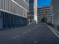 the empty street with bicycles parked in front of the buildings has a sign that says the library on it