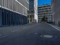 the empty street with bicycles parked in front of the buildings has a sign that says the library on it