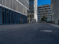 the empty street with bicycles parked in front of the buildings has a sign that says the library on it