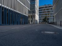 the empty street with bicycles parked in front of the buildings has a sign that says the library on it