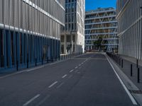 the empty street with bicycles parked in front of the buildings has a sign that says the library on it