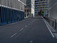 the empty street with bicycles parked in front of the buildings has a sign that says the library on it