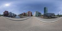 two fish - eye photos of a city in germany with buildings around it and a body of water