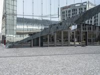 a glass building with a stair in front and outside view of it, and on another level there is a man walking