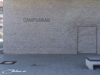 the old brick building is decorated with the name campus bed in cement blocks with graffiti on it