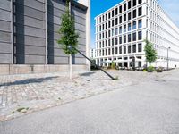 an empty street that has a stop sign in the middle of it near a building