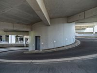 a car is driving on the highway through an underground parking garage area in a city