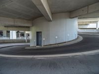 a car is driving on the highway through an underground parking garage area in a city