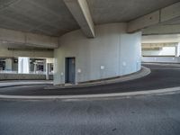 a car is driving on the highway through an underground parking garage area in a city