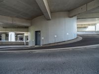 a car is driving on the highway through an underground parking garage area in a city