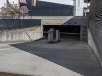 an american flag in the air over a parking garage area for car traffic and pedestrians