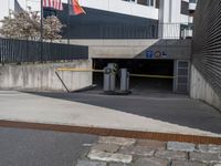 an american flag in the air over a parking garage area for car traffic and pedestrians