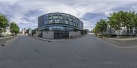 view up from inside a fish eye lens of a modern office building, on a street