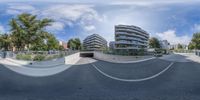 two mirrors are shown on a city street that appears to be in the reflection of a skateboard park