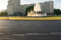 a traffic light is on and there is a large building with many windows and fountains