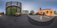 a fisheye view of an industrial area in a town setting with buildings and streets