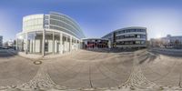 a 360 - lens view shows two buildings in the same picture, including a building and a walkway