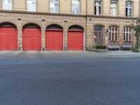 a firetruck outside the front doors of an old building on a street corner