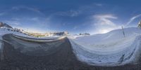 this is a picture of a winter road in the snow with a large mountain in the background