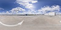 a 360 - ray lens picture shows the sky and clouds in a park like environment