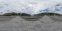 three mirrors in the shape of mountains on the street near a bike path and a mountain