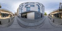 an image of two 360 - view photos of buildings, street and a bus stop