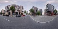 a curved street and parked cars are shown in this image that makes two shots together