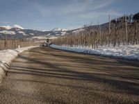 this rural country road has some skis hanging over it and there are snow on the ground